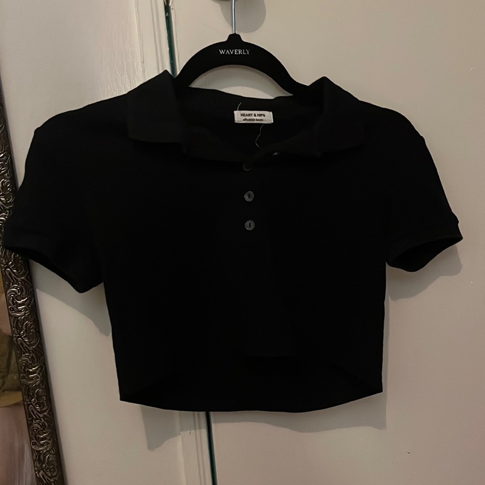 Crop top with collar and black buttons.